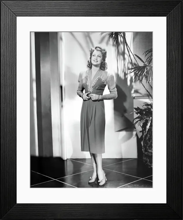 Framed Print : CAIRO, Jeanette MacDonald, in a blue cocktail frock with chiffon sleeves and sequin trim by Robert Kalloch, 1942