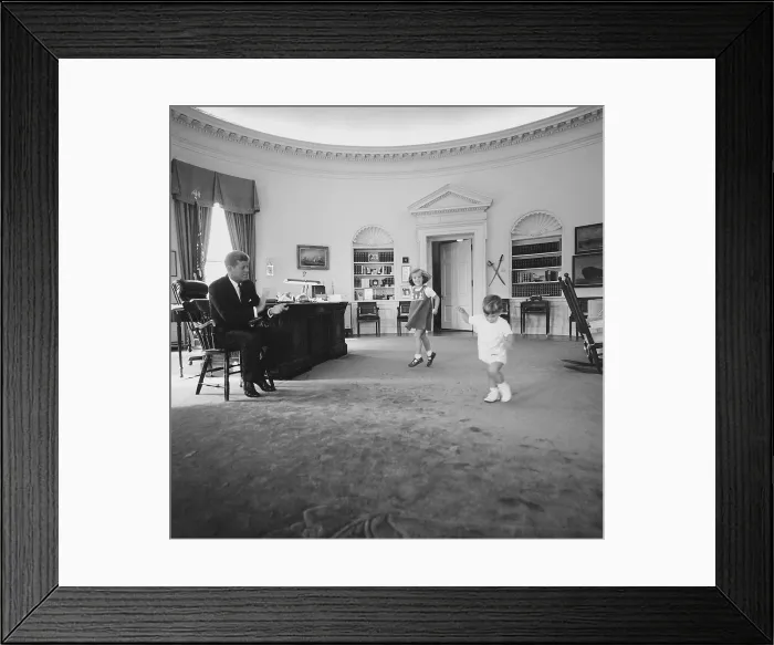 Framed Print : Caroline and John Jr. dance in the Oval Office as President Kennedy claps. 1962