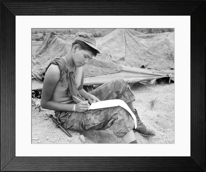 Framed Print : Vietnam War. Private First Class Joseph Big Medicine Jr. a Cheyenne Indian, writes a letter to his family in the United States
