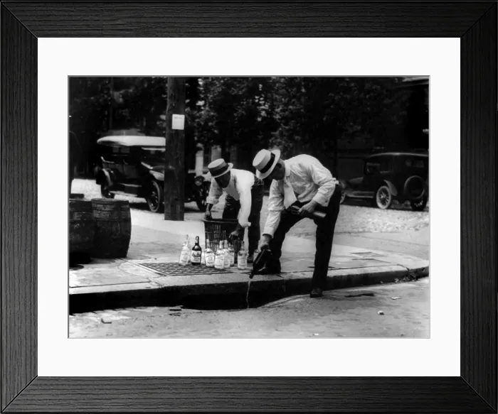 Framed Print : Prohibition, pouring whiskey into a sewer, circa 1909-1932 Framed Print : Prohibition, pouring whiskey into a sewer, circa 1909-1932