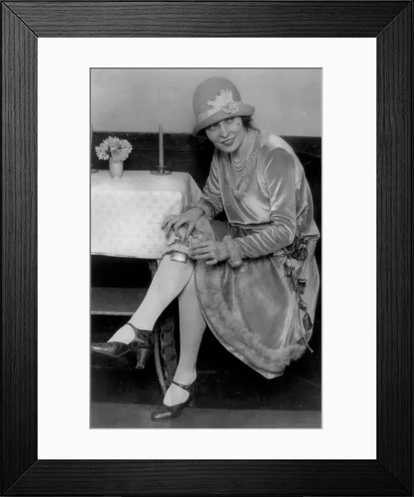 Framed Print : Prohibition, Miss Rhea seated with flask in garter on leg, original caption: Latest thing in flasks, Mlle
