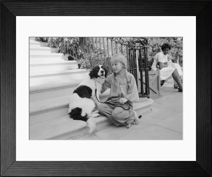 Framed Print : First daughter Amy Carter with her dog, Grits. The dog was a gift from her teacher. Ca. 1978