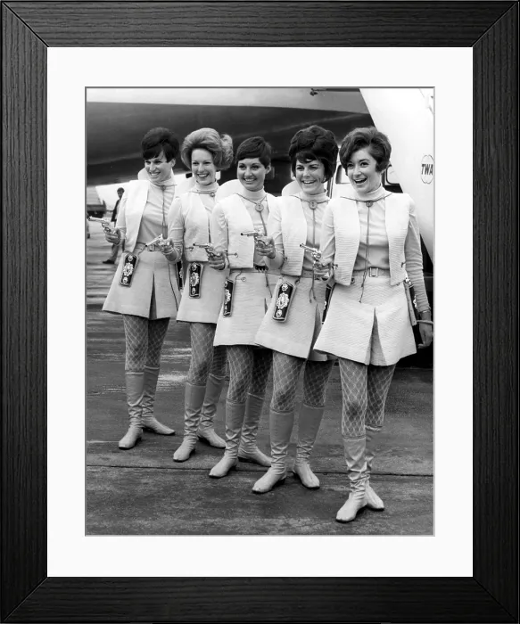 Framed Print : LONDON: These Western Air Lines hostesses are packing pisotls for a reason