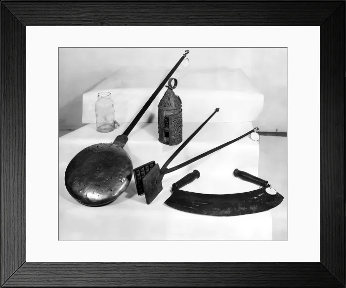Framed Print : Kitchenware, Early American household appliances, l-r: fruit jar, brass bed warmer, town crier's lantern (back), antique waffle iron, meat tenderizer Framed Print : Kitchenware, Early American household appliances, l-r: fruit jar, brass bed warmer, town crier's lantern (back), antique waffle iron, meat tenderizer