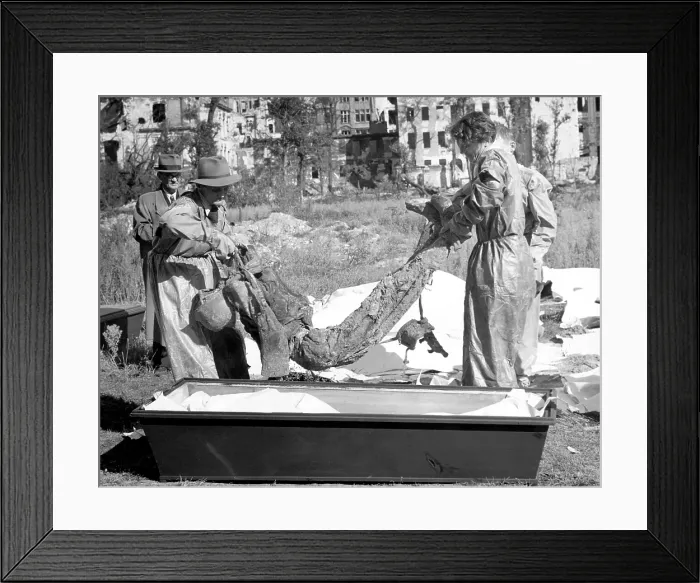 Framed Print : The bodies of murdered political prisoners buried around Gestapo headquarters being disinterred for examination. Cologne, Germany, October 15, 1945 Framed Print : The bodies of murdered political prisoners buried around Gestapo headquarters being disinterred for examination. Cologne, Germany, October 15, 1945