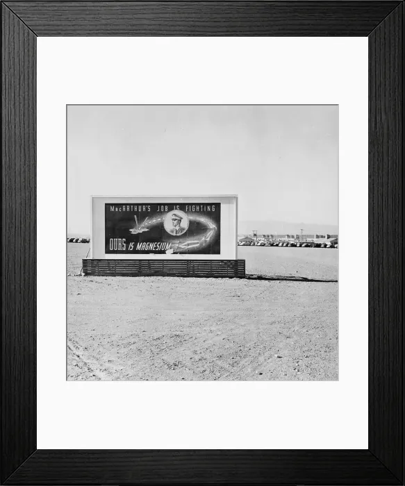 Framed Print : Las Vegas, Nevada, a billboard on the grounds of the Basic Magnesium Incorporated plant reading MacArthur's job is fighting. OURS is magnesium. circa 1942
