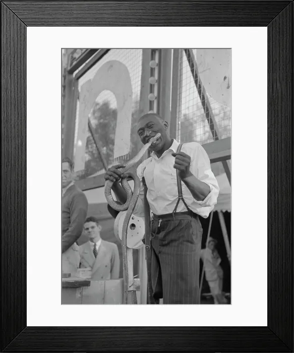 Framed Print : One-legged Geek biting the head of a snake at a sideshow, Louisiana State Fair, 1938 Framed Print : One-legged Geek biting the head of a snake at a sideshow, Louisiana State Fair, 1938
