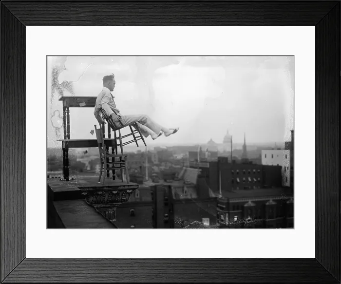 Framed Print : Jammie Reynolds, balancing on the on chairs on the edge of a rooftop in Washington, DC ca. 1917