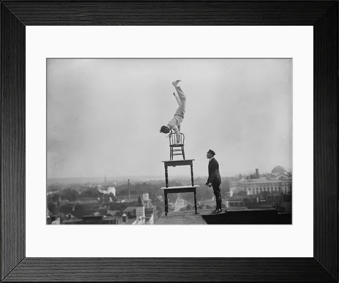 Framed Print : Jammie Reynolds, balancing on the on chairs on the edge of a rooftop in Washington, DC ca. 1921