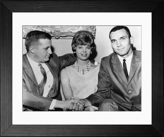 Framed Print : George Steinbrenner (left), shakes hands with Jerry Lucas (right), All-American basketball player. his wife Treva Lucas, Jerry's wife, sits between them
