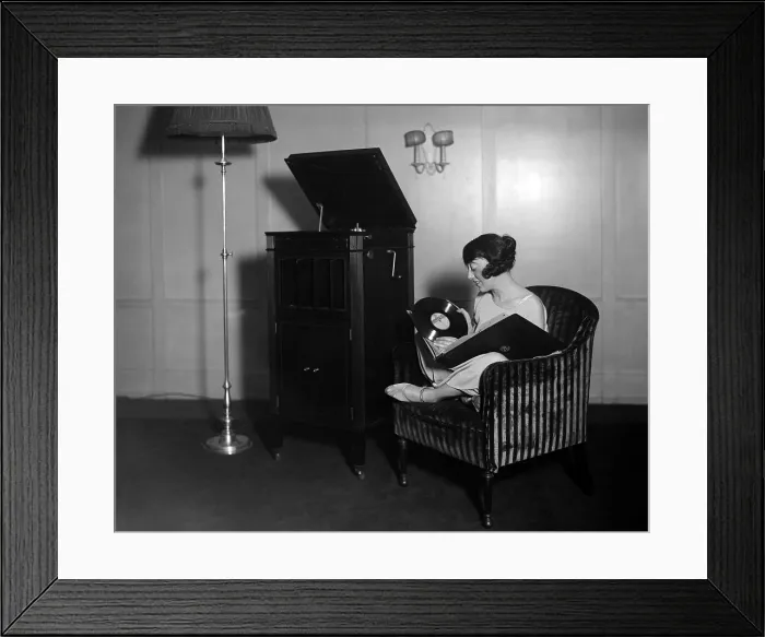 Framed Print : Woman with record albums and victrola, circa 1930s