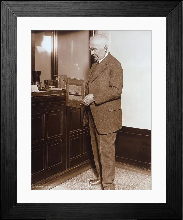 Framed Print : Emile Berliner (1851-1929), American inventor of the phonograph, holding a microphone first used on April 8, 1877, circa 1910s