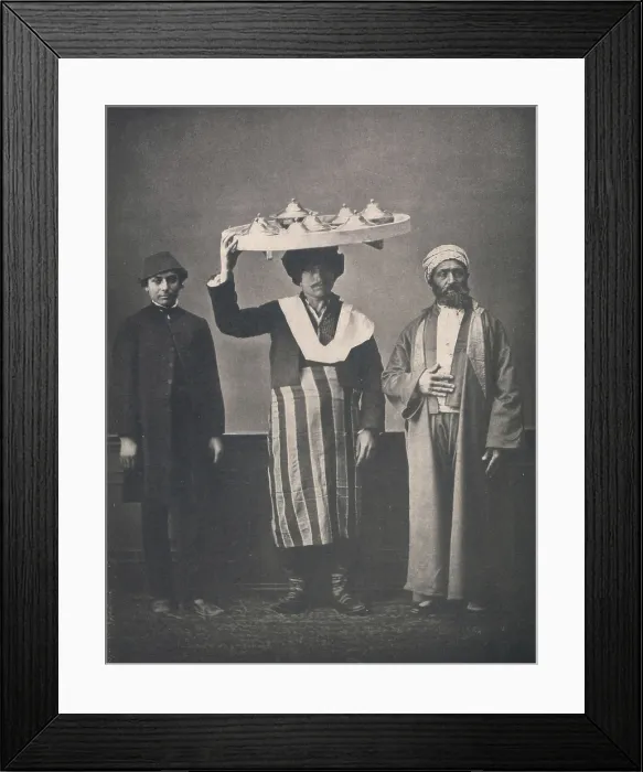 Framed Print : The Ottoman Empire, studio portrait of models wearing clothing from Istanbul, Bourgeois Muslim man of Constantinople in Europeanized dress, servant carrying tray on head Framed Print : The Ottoman Empire, studio portrait of models wearing clothing from Istanbul, Bourgeois Muslim man of Constantinople in Europeanized dress, servant carrying tray on head