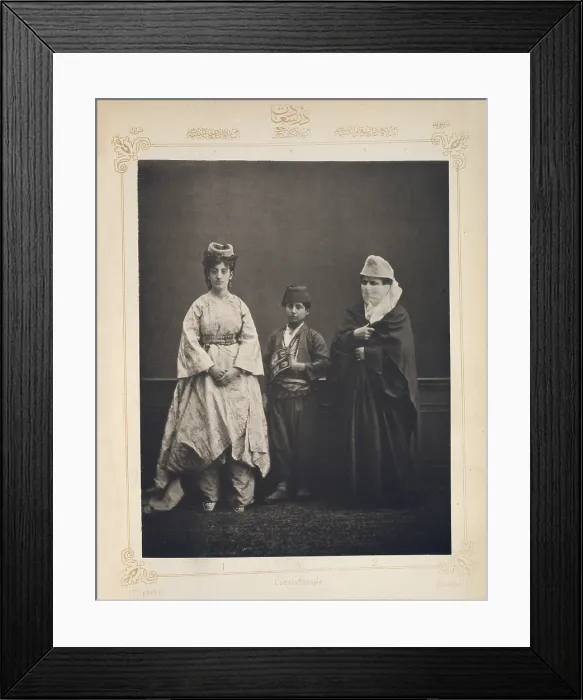 Framed Print : The Ottoman Empire, studio portrait of models wearing traditional clothing from Istanbul, Turkish woman of Constantinople wearing indoor dress, Turkish schoolboy