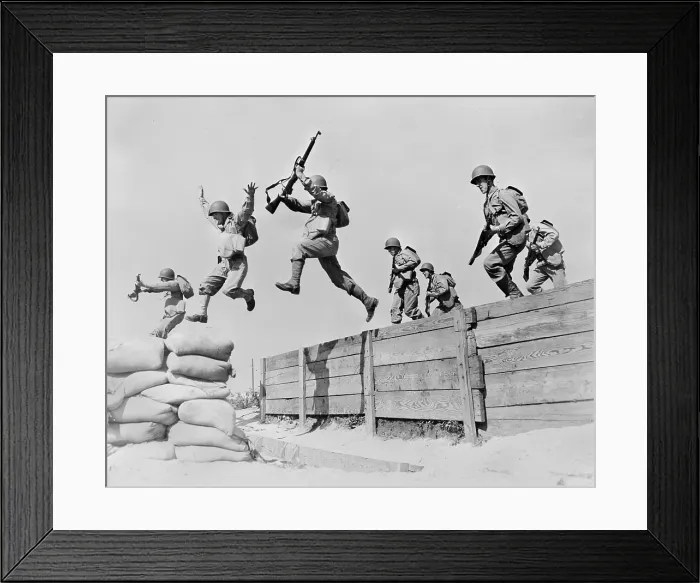 Framed Print : World War II, original caption: A hard-running leap takes these artillerymen over one of the obstacles on the course at the anti-aircraft training center Framed Print : World War II, original caption: A hard-running leap takes these artillerymen over one of the obstacles on the course at the anti-aircraft training center