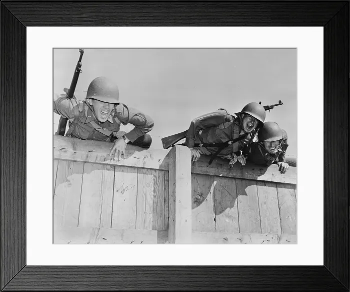 Framed Print : World War II, original caption: Officers are shown completing the final obstacles of a tough course, topping the six-foot wall, the last part of the under-and-over obstacles Framed Print : World War II, original caption: Officers are shown completing the final obstacles of a tough course, topping the six-foot wall, the last part of the under-and-over obstacles