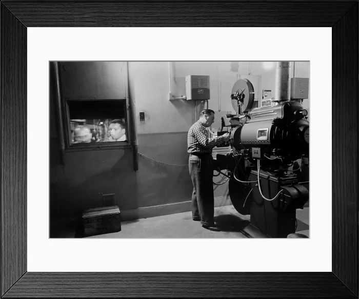 Framed Print : Man working a projector in a movie theater, photo by Marion S. Trikosko, February 9, 1958
