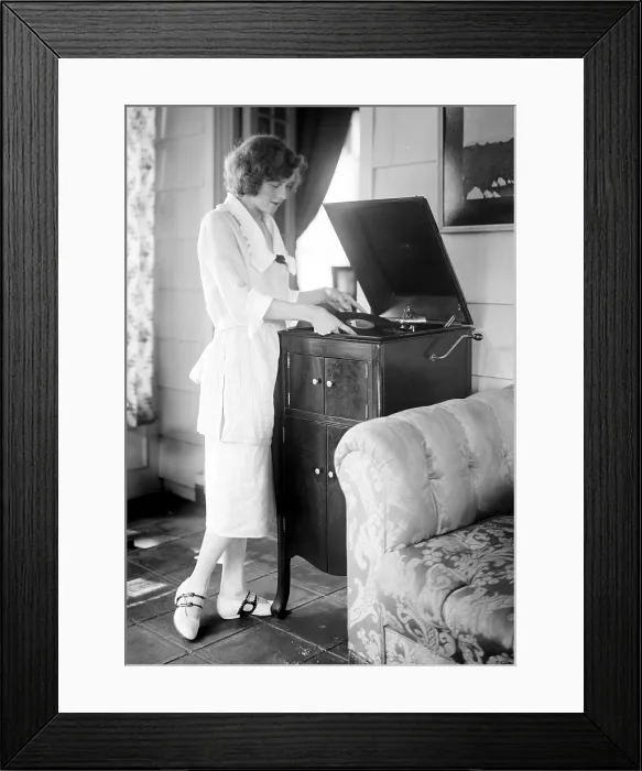 Framed Print : Woman playing a record, circa 1930s