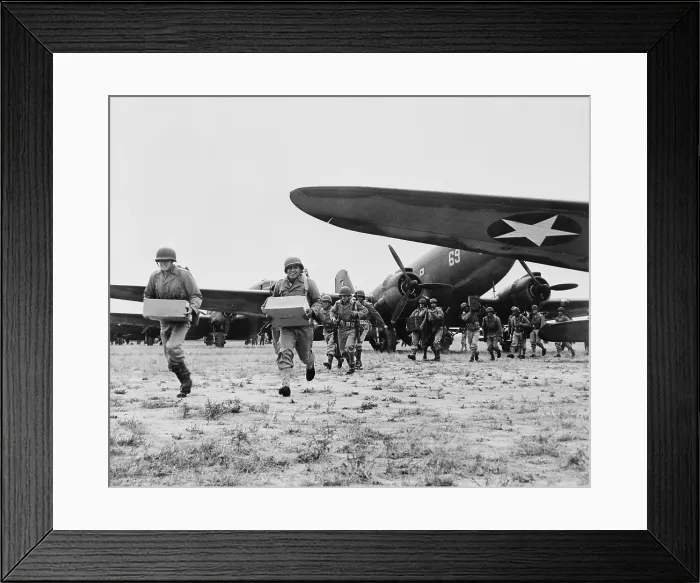 Framed Print : World War II, landing operation of U.S. Airborne infantry force in the southwestern United States. The troops unloading supplies and ammunition from transport planes, circa 1942