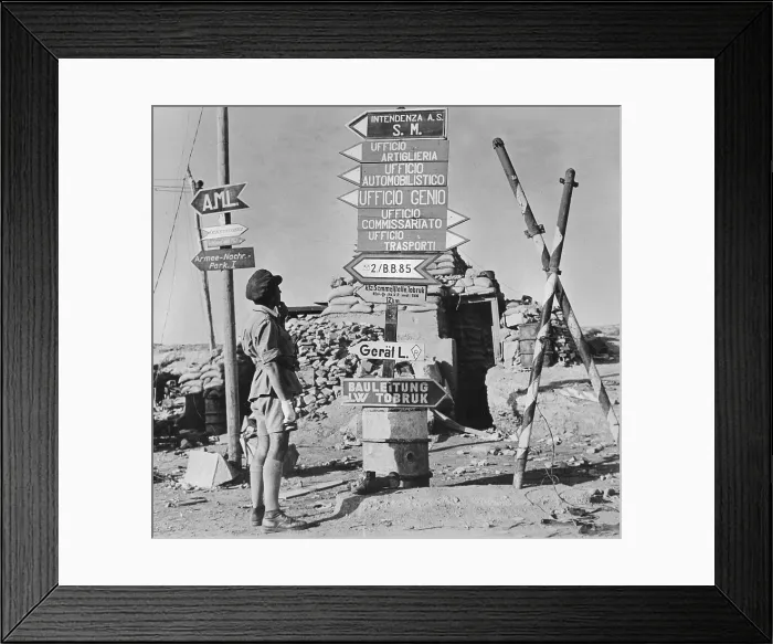 Framed Print : World War II, signposts printed in German and Italian point to former Axis offices, a street corner, Tobruk, Libya, circa 1942