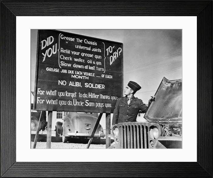Framed Print : World War II, U.S. soldier at base in front of patriotic message, circa 1940-1946 Framed Print : World War II, U.S. soldier at base in front of patriotic message, circa 1940-1946