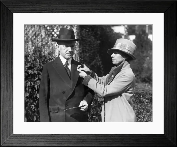 Framed Print : First Lady Grace Coolidge pins a Red Cross button on President Calvin Coolidge's coat, 1925. Courtesy: CSU Archives / Everett Collection