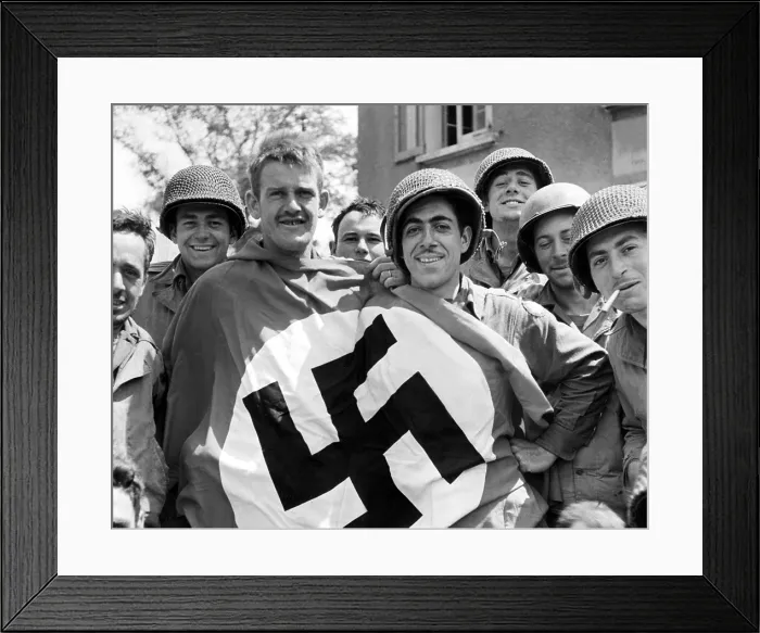 Framed Print : CHERBOURG, FRANCE-- A comandeered Nazi flag held by American soldiers after the liberation of Cherbourg, July 1, 1944. Courtesy: CSU Archives  /  Everett Collection