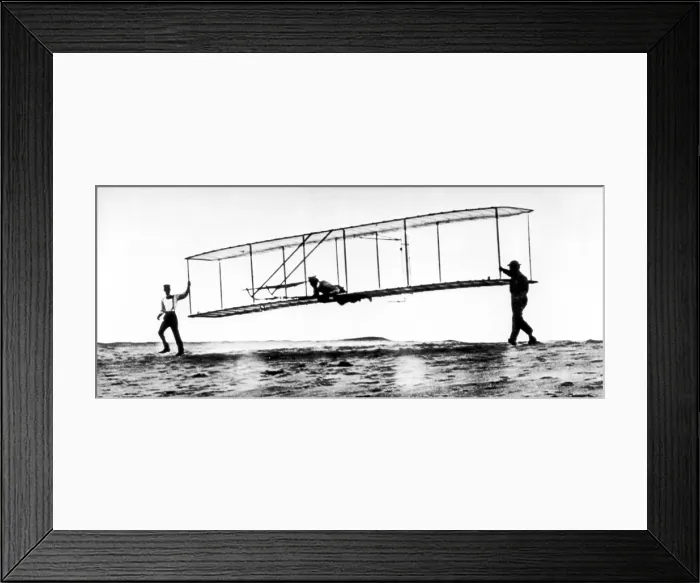 Framed Print : The modified No. 3 Glider (1902) being launched at Kill Devil Hill, with Orville Wright piloting as brother Wilbur helps.. Courtesy: CSU Archives  /  Everett Collection