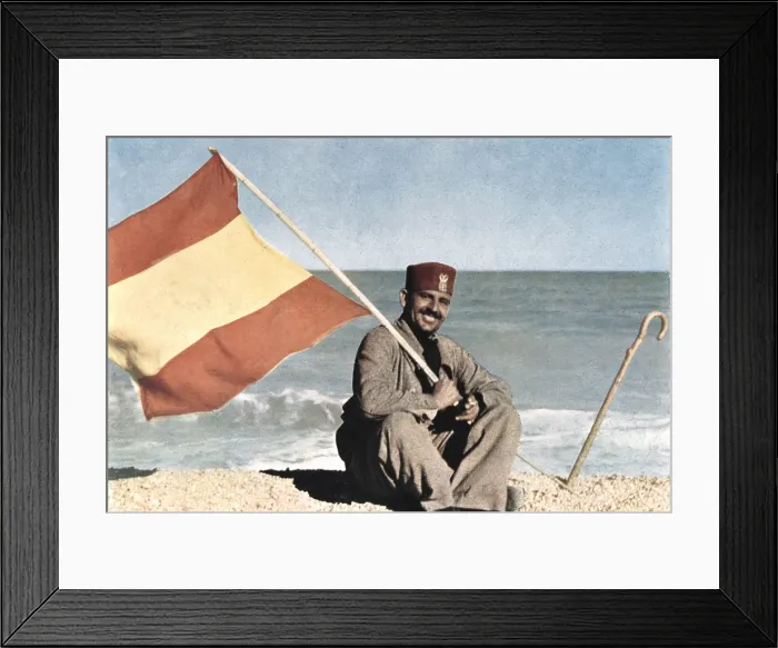 Framed Print : Spain. Protectorate of Morocco (1936). 'The Flag of the Motherland is Waving in the Mediterranean Winds'. Soldier of the African Army waving an Spanish flag Framed Print : Spain. Protectorate of Morocco (1936). 'The Flag of the Motherland is Waving in the Mediterranean Winds'. Soldier of the African Army waving an Spanish flag