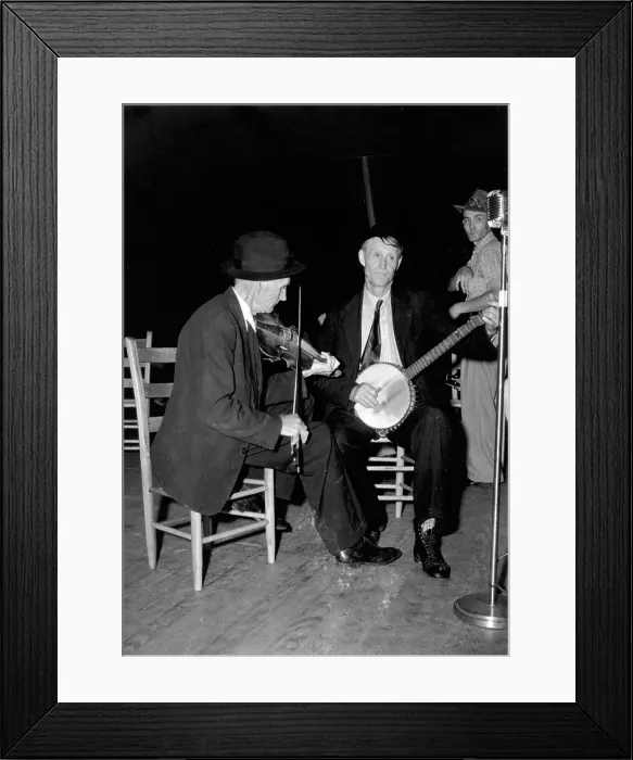 Framed Print : R. J. Boyd, playing fiddle, and Millard Garrett, playing banjo, both from Sandy Mush, North Carolina, at the the Mountain Music Festival, Asheville, North Carolina, 1938-1950