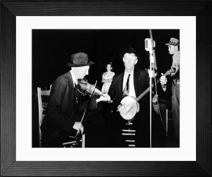 Framed Print : R. J. Boyd, playing fiddle, and Millard Garrett, playing banjo, both from Sandy Mush, North Carolina, at the the Mountain Music Festival, Asheville, North Carolina, 1938-1950