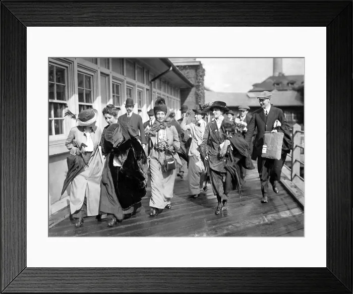 Framed Print : Mrs. Emmeline Pankhurst, the English militant leader (center), is shown leaving Ellis Island today with party of suffragists after President Wilson had ordered her release Framed Print : Mrs. Emmeline Pankhurst, the English militant leader (center), is shown leaving Ellis Island today with party of suffragists after President Wilson had ordered her release