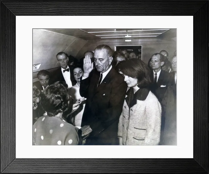 Framed Print : Johnson taking oath. Ladybird Johnson and former first lady Jacqueline Kennedy witness U.S. District Judge Sarah T. Hughes administering the oath of office to Lyndon B