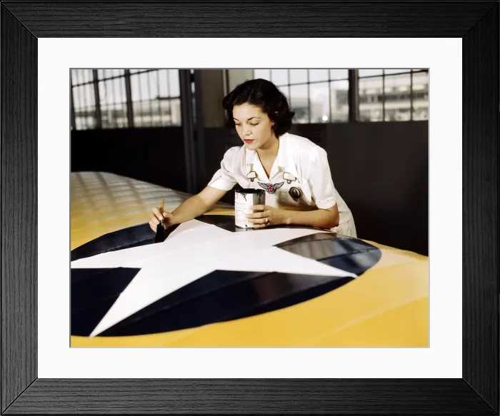 Framed Print : Civil service worker paints the American insignia on a US Navy airplane wing, Naval Air Base, Corpus Christi, Texas 1942