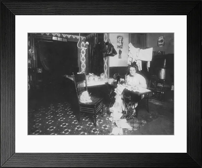 Framed Print : Woman working in basement, from caption: Annie Maier (or Meyer), making Campbell-kids pinafores in her basement home. 71 E. 108 Street