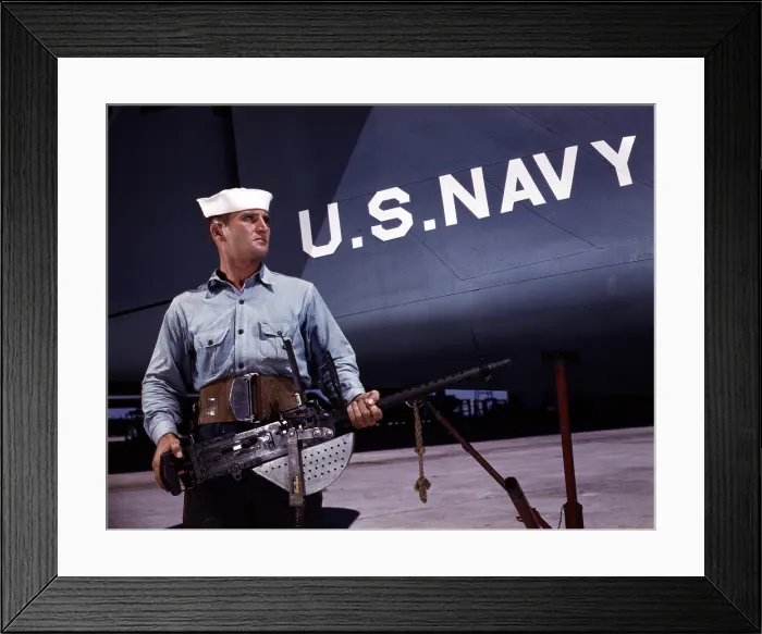 Framed Print : A sailor holds a.30 caliber machine gun at the Naval Air Base, Corpus Christi, TX, 1942