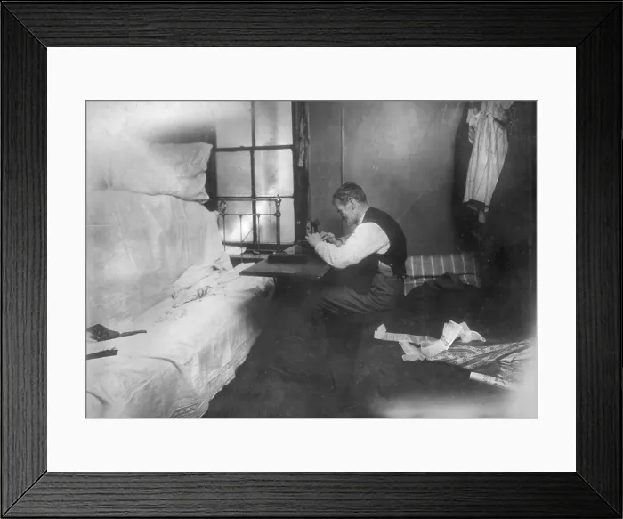 Framed Print : Mr. Rothenberg stitching neckties in small inner bedroom, New York City, photograph by Lewis Wickes Hine, February, 1912