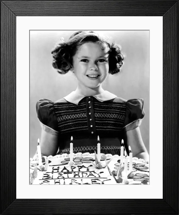 Framed Print : JUST AROUND THE CORNER, Shirley Temple with her birthday cake, on set, 1938. 20th Century-Fox Film Corporation, TM & Copyright / courtesy Everett Collection