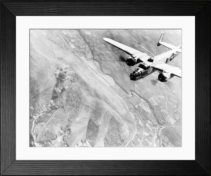 Framed Print : A Nazi supply dump goes up in smoke. A U.S. B-25 medium bomber roars over Tivoli, Nazi supply center ten miles east of Rome