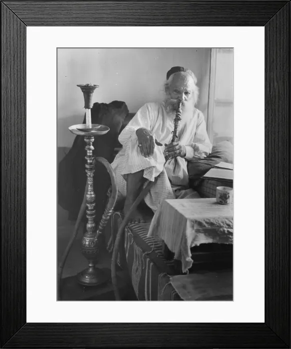 Framed Print : Seated man smoking a nargile, or water pipe, photograph, 1898-1946