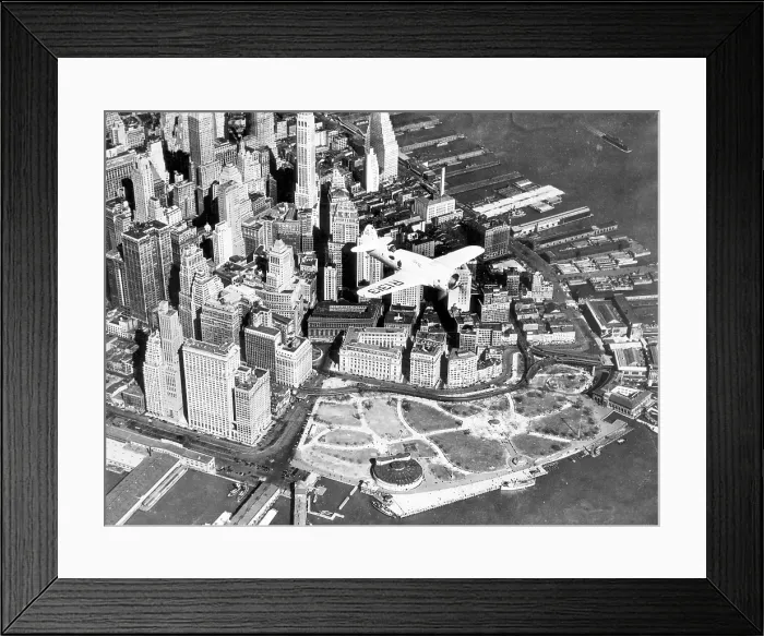 Framed Print : Captain Frank Hawks new Speed Plane flying over Manhattan's financial district and Battery Park, New York City, April 3, 1937. Courtesy: CSU Archives / Everett Collection