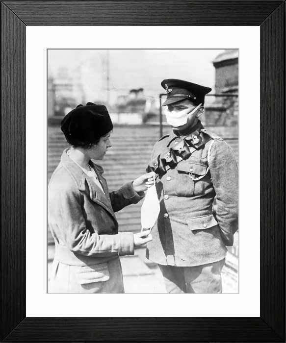 Framed Print : Respirator for British soldiers- a nurse demonstrates a facemask on a British soldier during the influenza epidemic, ca. 1918
