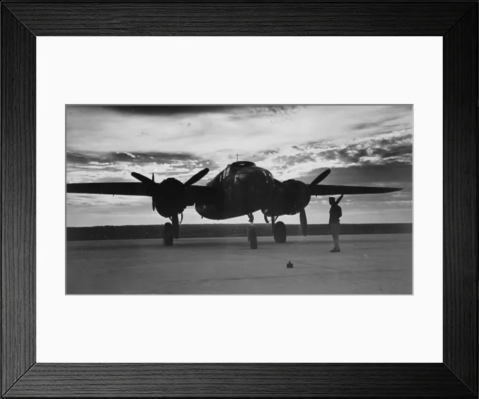 Framed Print : World War II, soldier beside WWII airplane at sunrise, circa early 1940s Framed Print : World War II, soldier beside WWII airplane at sunrise, circa early 1940s