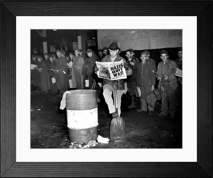 Framed Print : German prisoners of war in New York on the day Germany surrendered, ending the war in Europe. The newspaper headline reads: Nazis Quit War. V-E Day Today, May 8, 1945