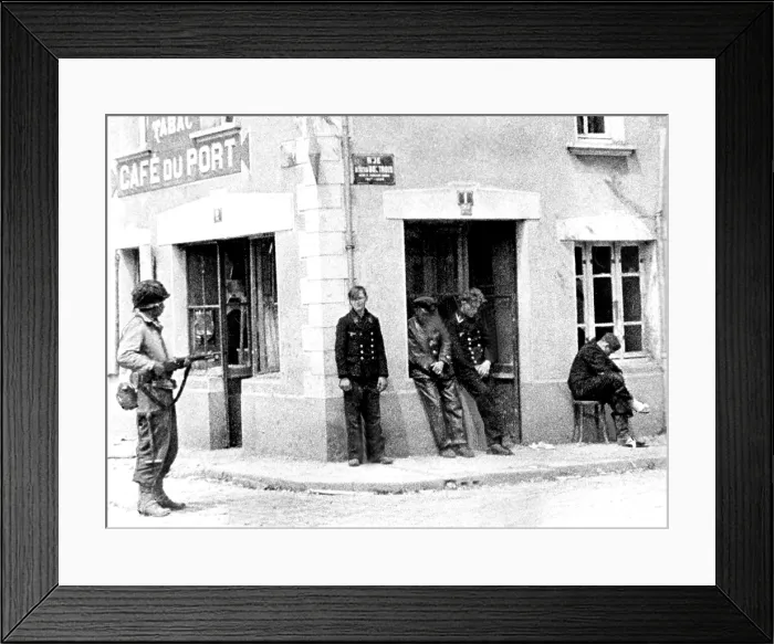 Framed Print : NORMANDY, from Army Signal Corps film, an unidentified American GI stands guard over four Nazis in the streets of Ste. Mere Eglise. Courtesy: CSU Archives  /  Everett Collection
