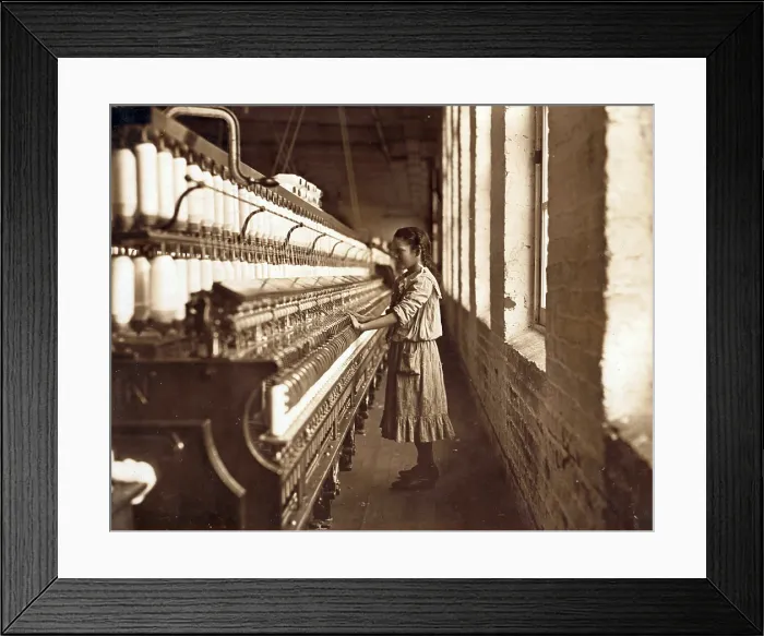 Framed Print : Cotton Mill. An underage girl tends a cotton spinner for 48 cents a day. Whitnel, North Carolina. Photo by Lewis Hine Wickes, Dec 1908