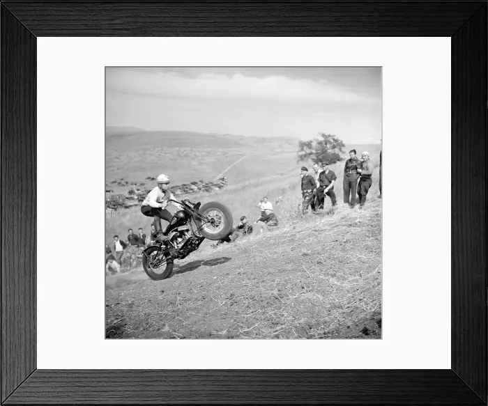Framed Print : An early motorcycle club watches as a member pops a wheelie on an uphill climb. Santa Clara County, California ca. 1940 Framed Print : An early motorcycle club watches as a member pops a wheelie on an uphill climb. Santa Clara County, California ca. 1940