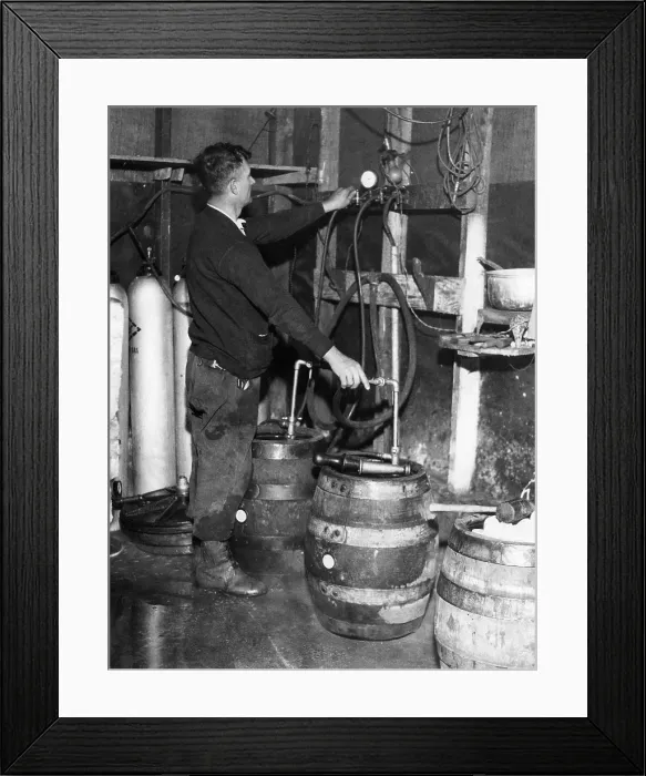 Framed Print : A brewmeister fills kegs at a bootleg brewery during Prohibition, 1933. Courtesy: CSU Archives / Everett Collection