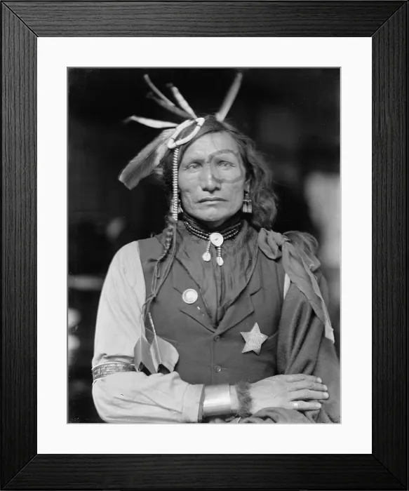 Framed Print : Iron White Man, a Native American man of the Sioux tribe, probably a member of Buffalo Bill's Wild West Show, wearing headdress and a Buffalo Falls Police star-shaped badge