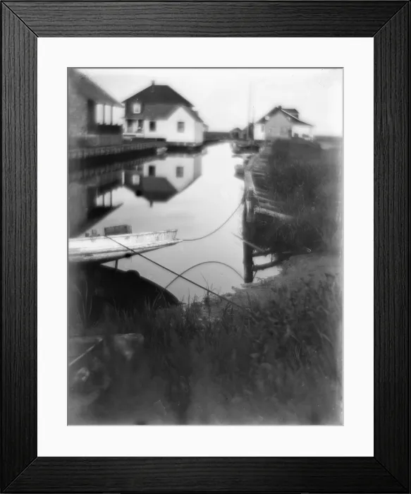 Framed Print : Bungalows at the water's edge in Oceanside, a small passageway of water flanked by houses and docks, Long Island, New York, photograph by Gertrude Kasebier, 1905
